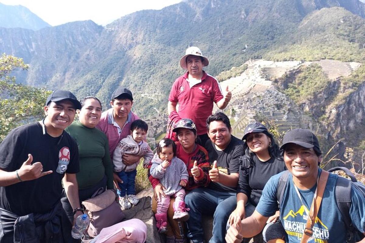 a group of people posing for a picture on a mountain