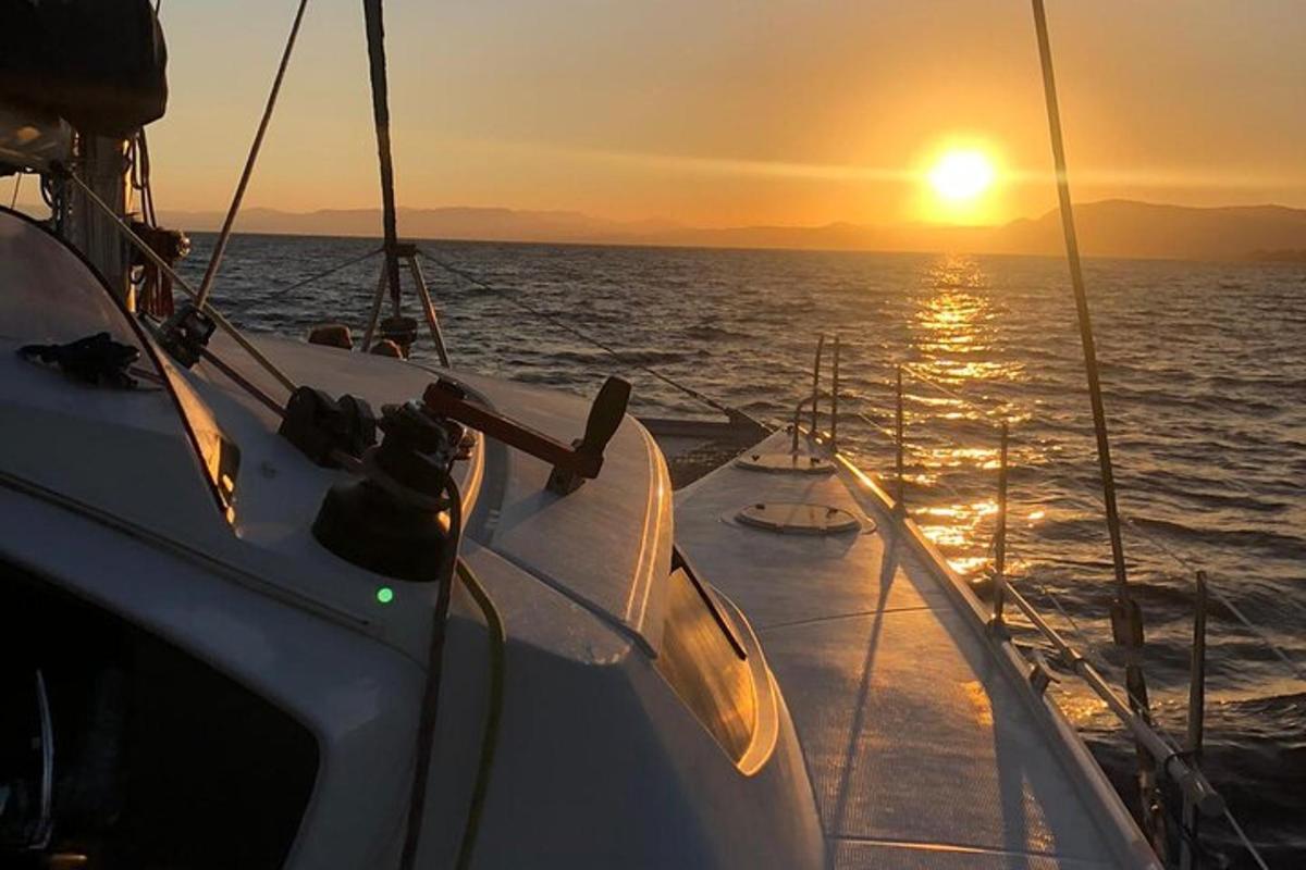 una barca nell'oceano con il tramonto sullo sfondo