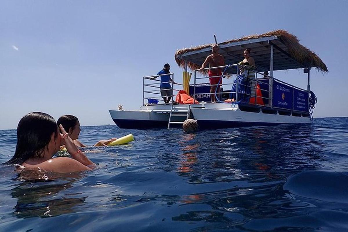 a group of people on a boat in the water