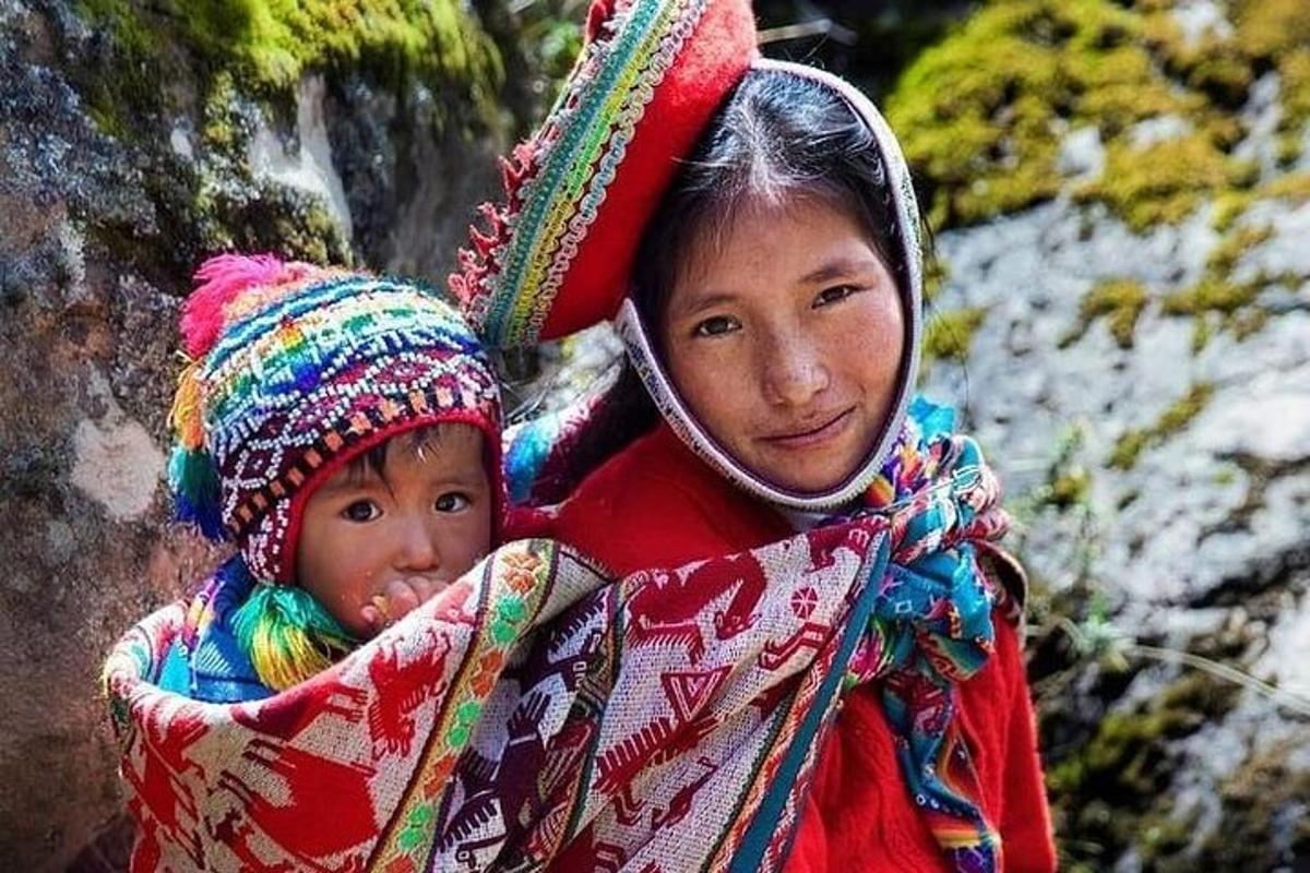 a woman carrying a child on her back