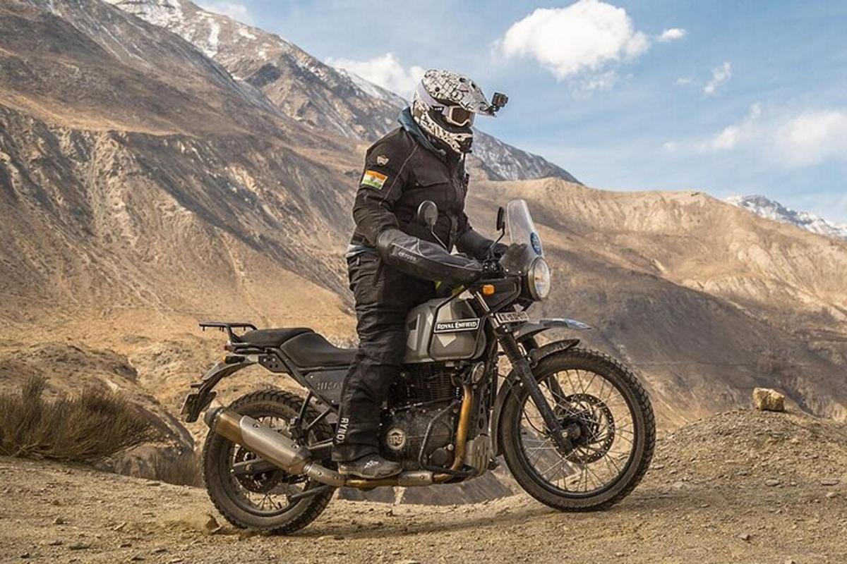 a man riding a motorcycle on a mountain
