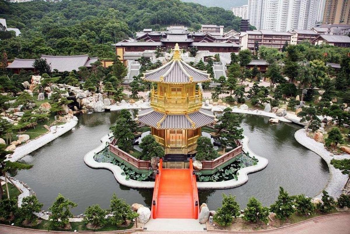 a large pagoda in the middle of a lake in a city