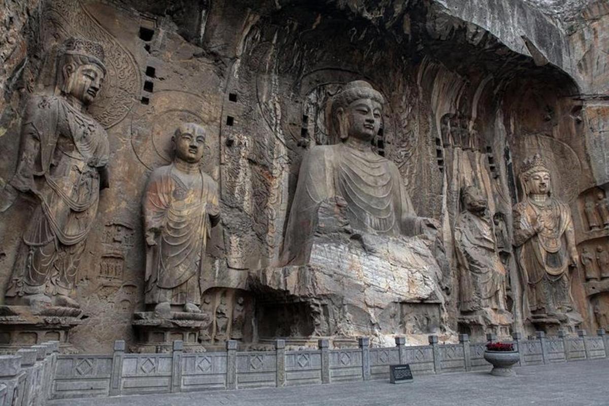 a large stone wall with statues on it