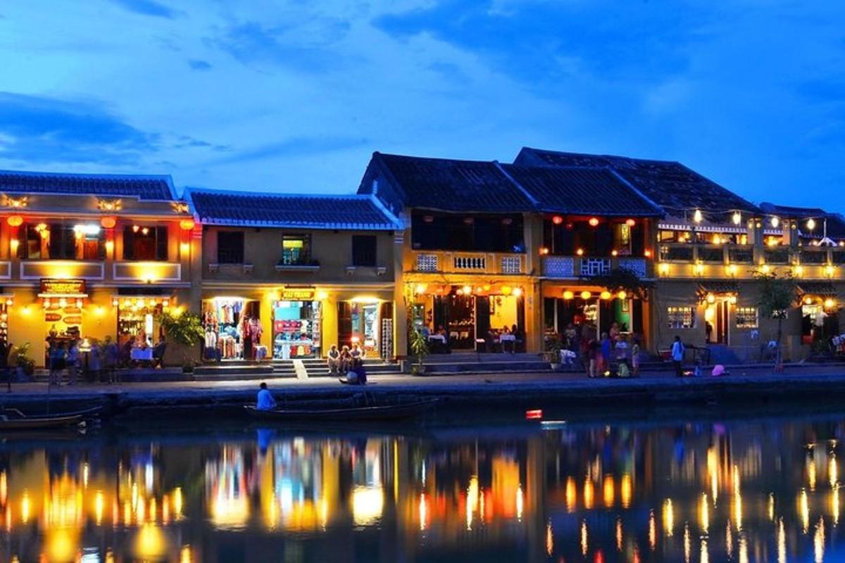 a group of buildings by the water at night
