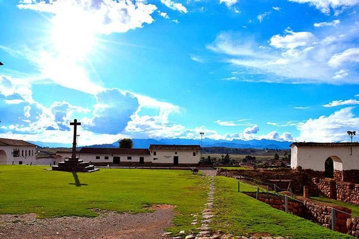 a view of a church with the sun in the sky