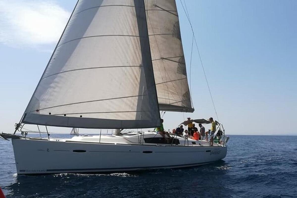 a group of people on a sail boat in the water