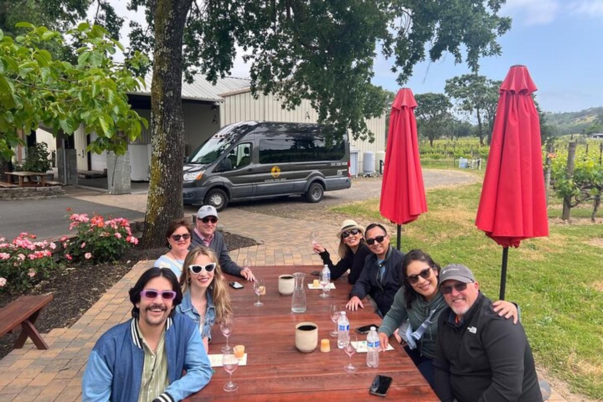 a group of people sitting around a wooden table