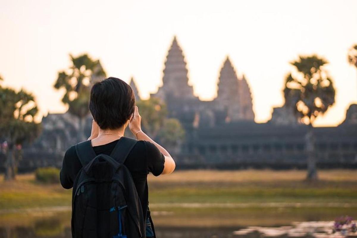 a man with a backpack talking on a cell phone