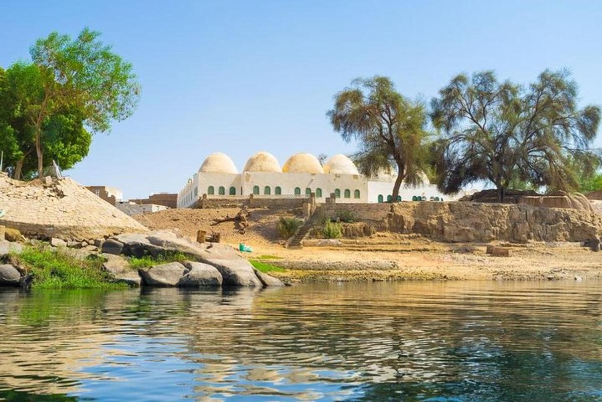 a building with domes on the shore of a body of water