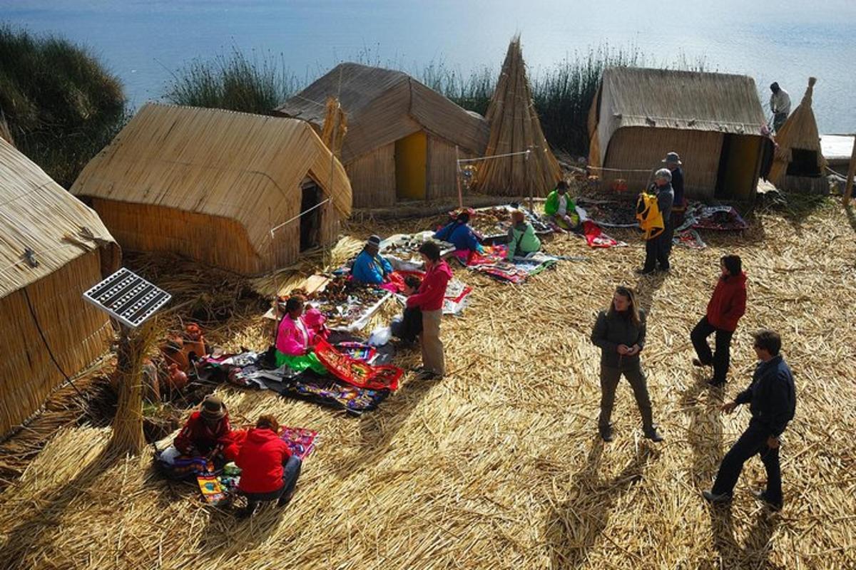 un grup de persones assegudes a terra en un poble