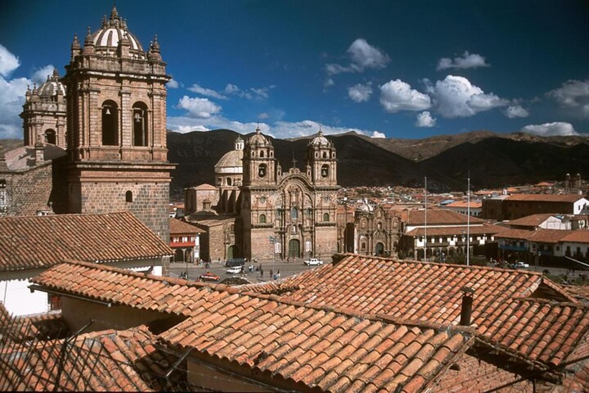 a view of a city with a church and roofs
