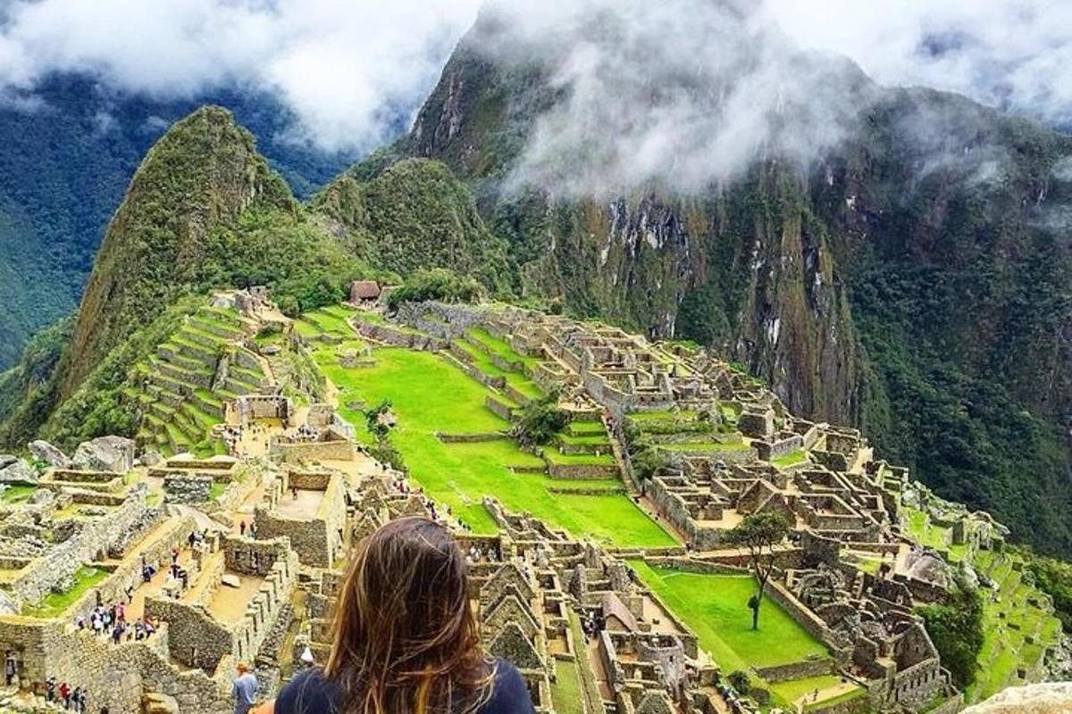 a woman looking up at the ruins of a mountain