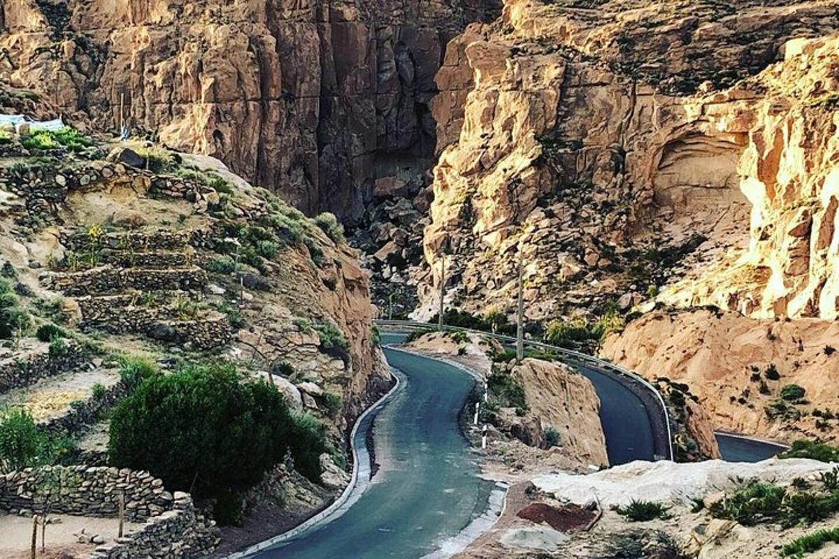 a winding road in a canyon in the desert