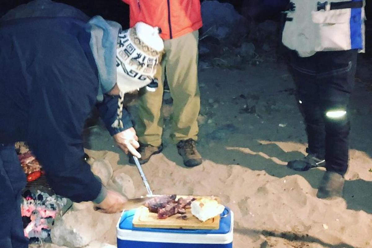 a person cutting a piece of food on a table