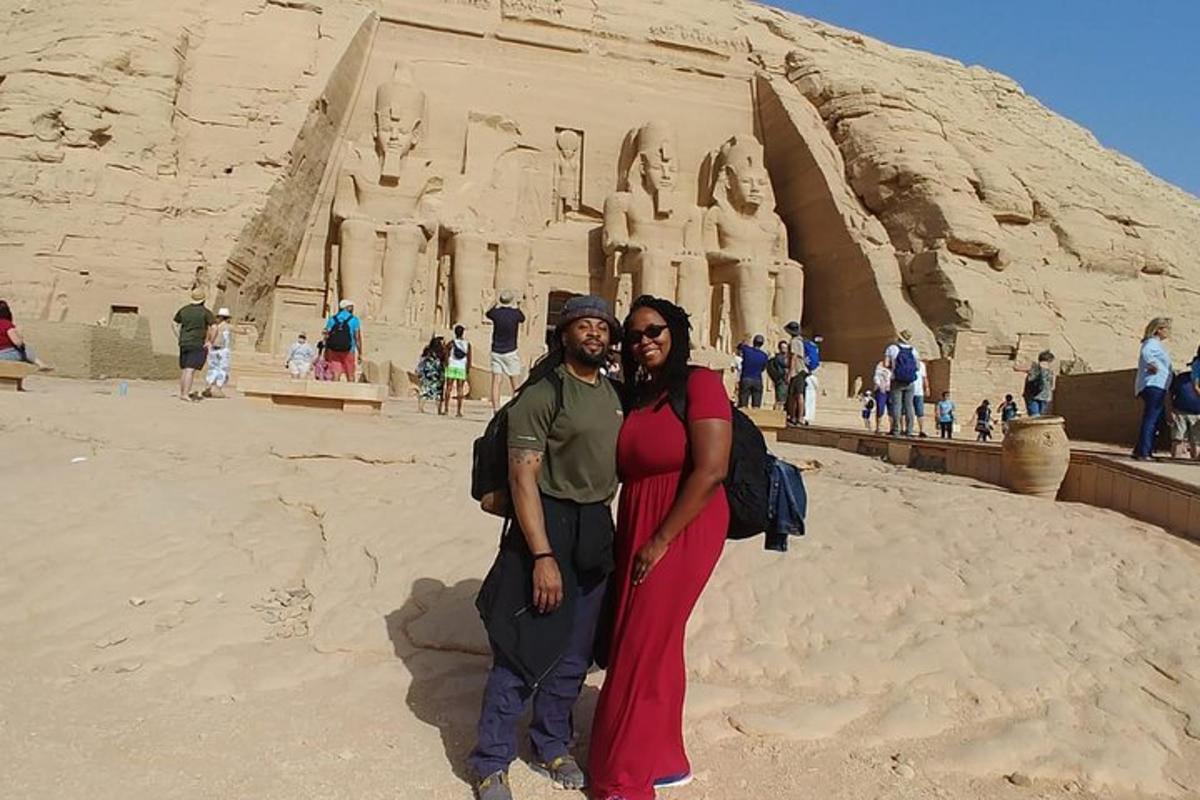 um homem e uma mulher em pé em frente a um monumento