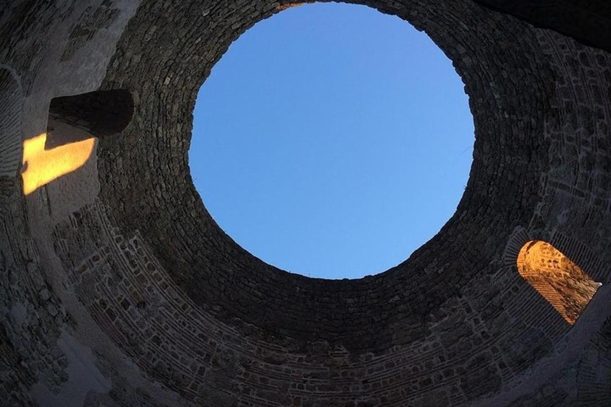a round window in a building with a blue sky