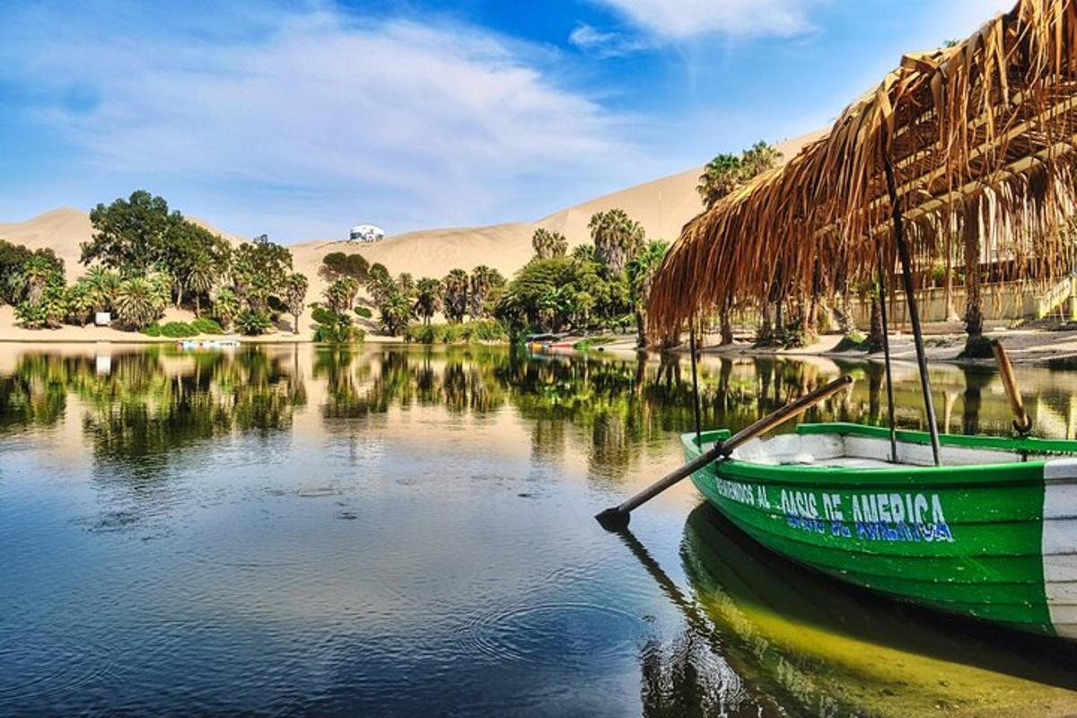 a green boat sitting in the water on a lake