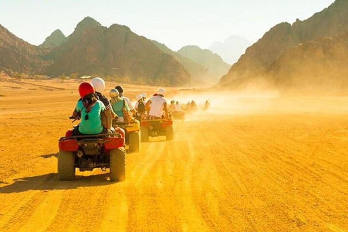 a group of people riding on motorcycles on a dirt road