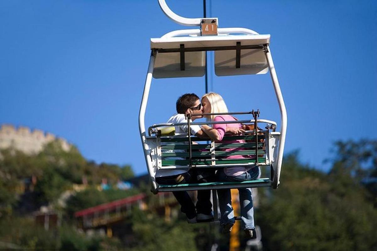 a man and woman riding on a ski lift