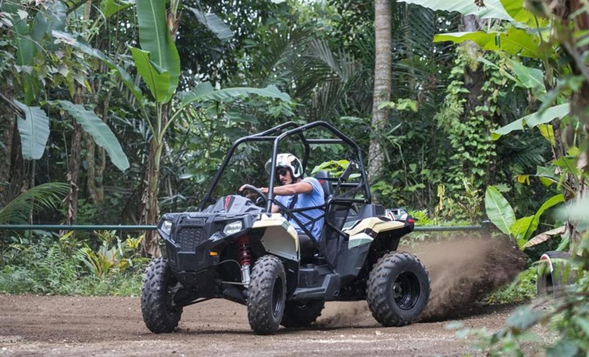 a man riding a atv on a dirt road