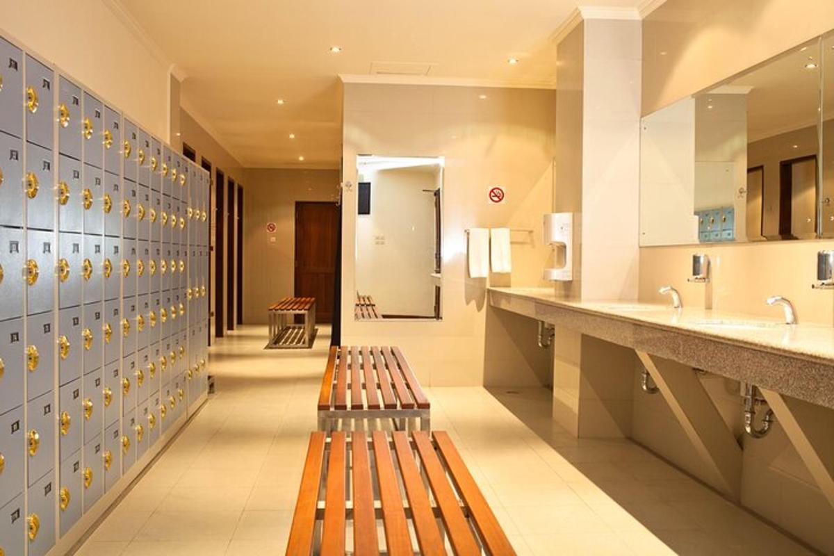 a hallway with two benches in a bathroom