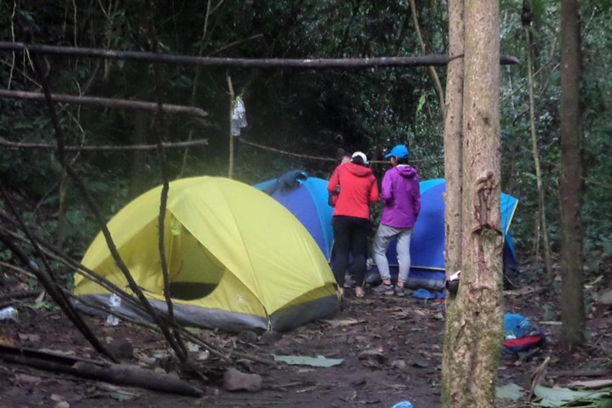 a group of people standing next to a tent
