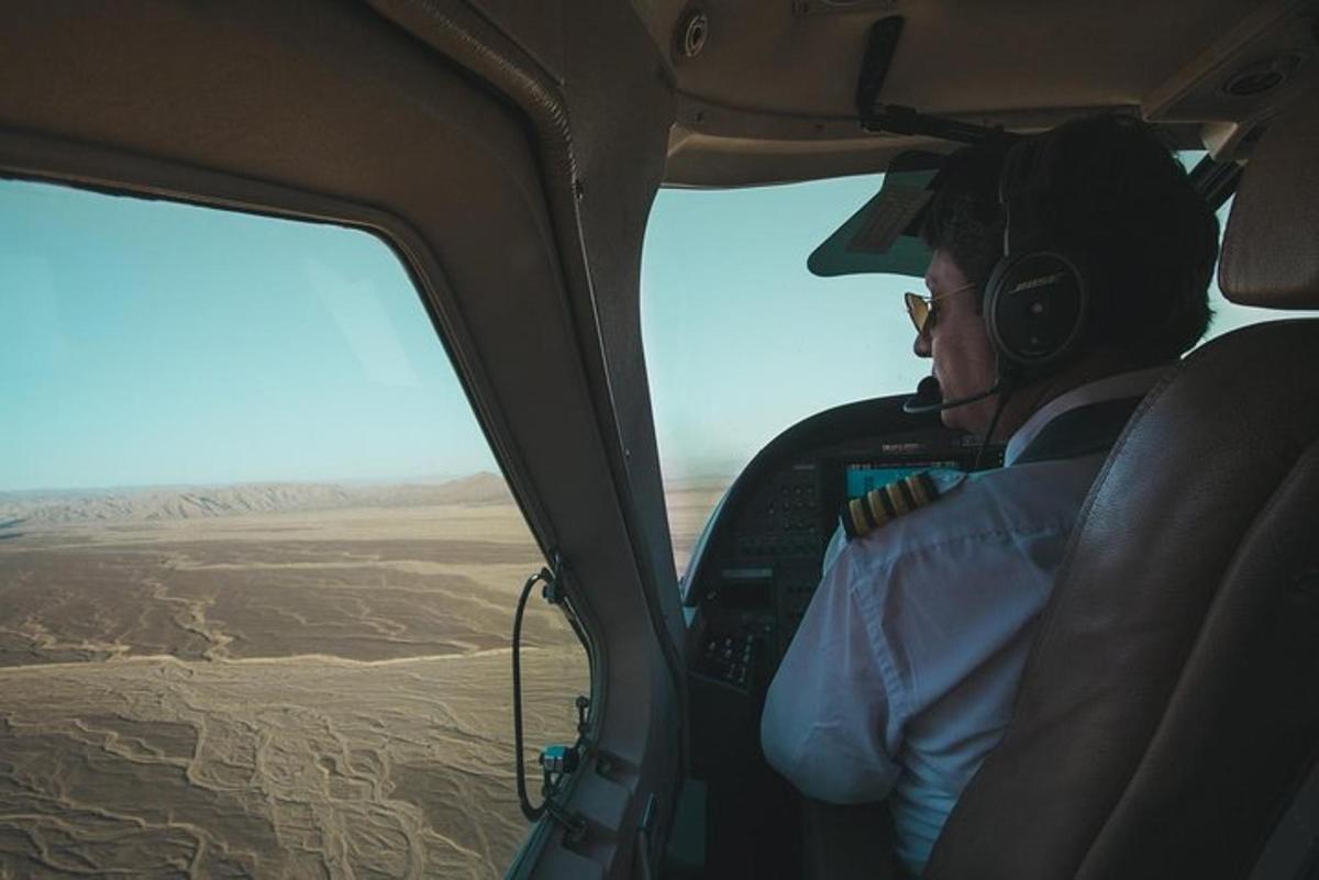 a man sitting in the cockpit of a helicopter