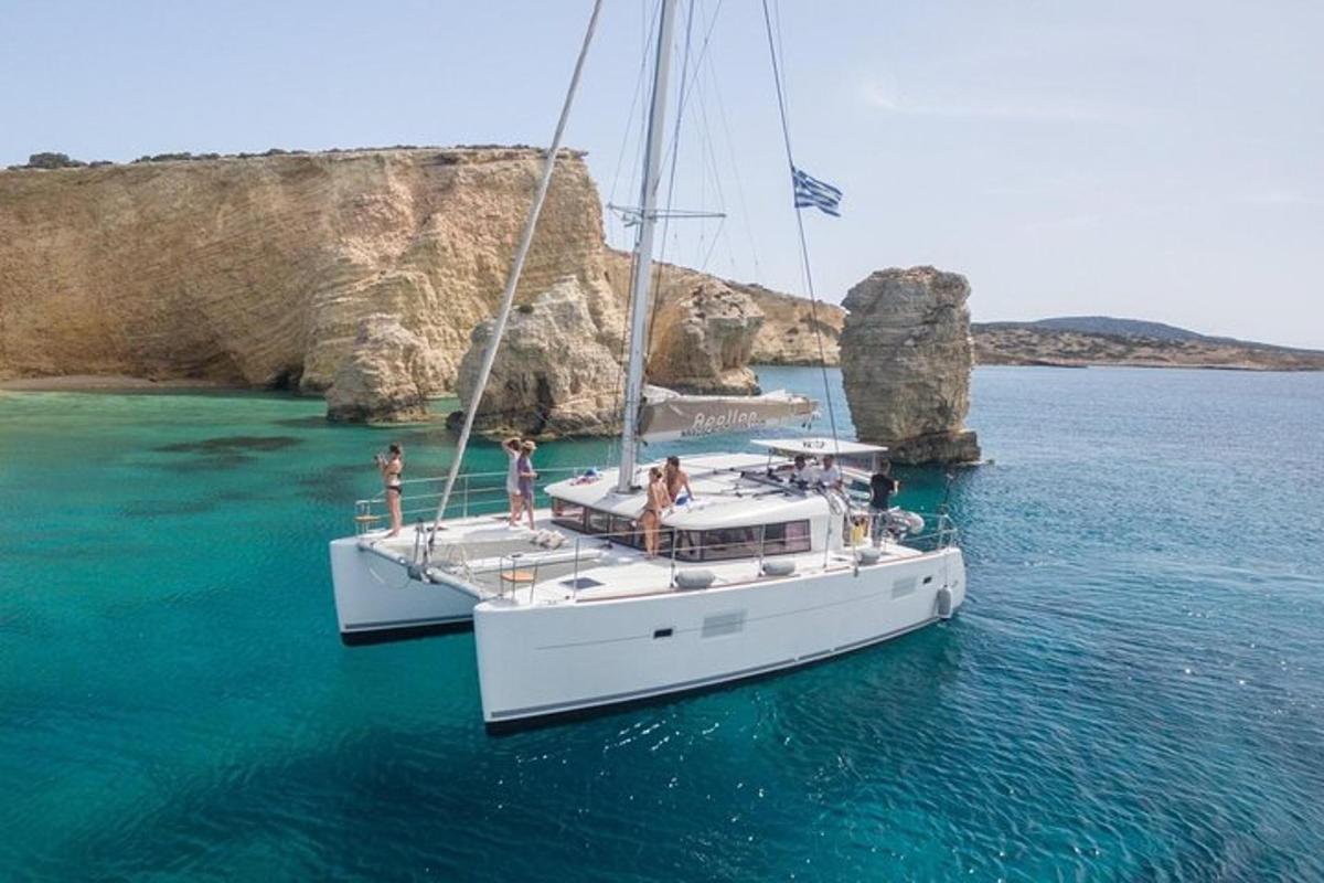 a white boat in the water with people on it