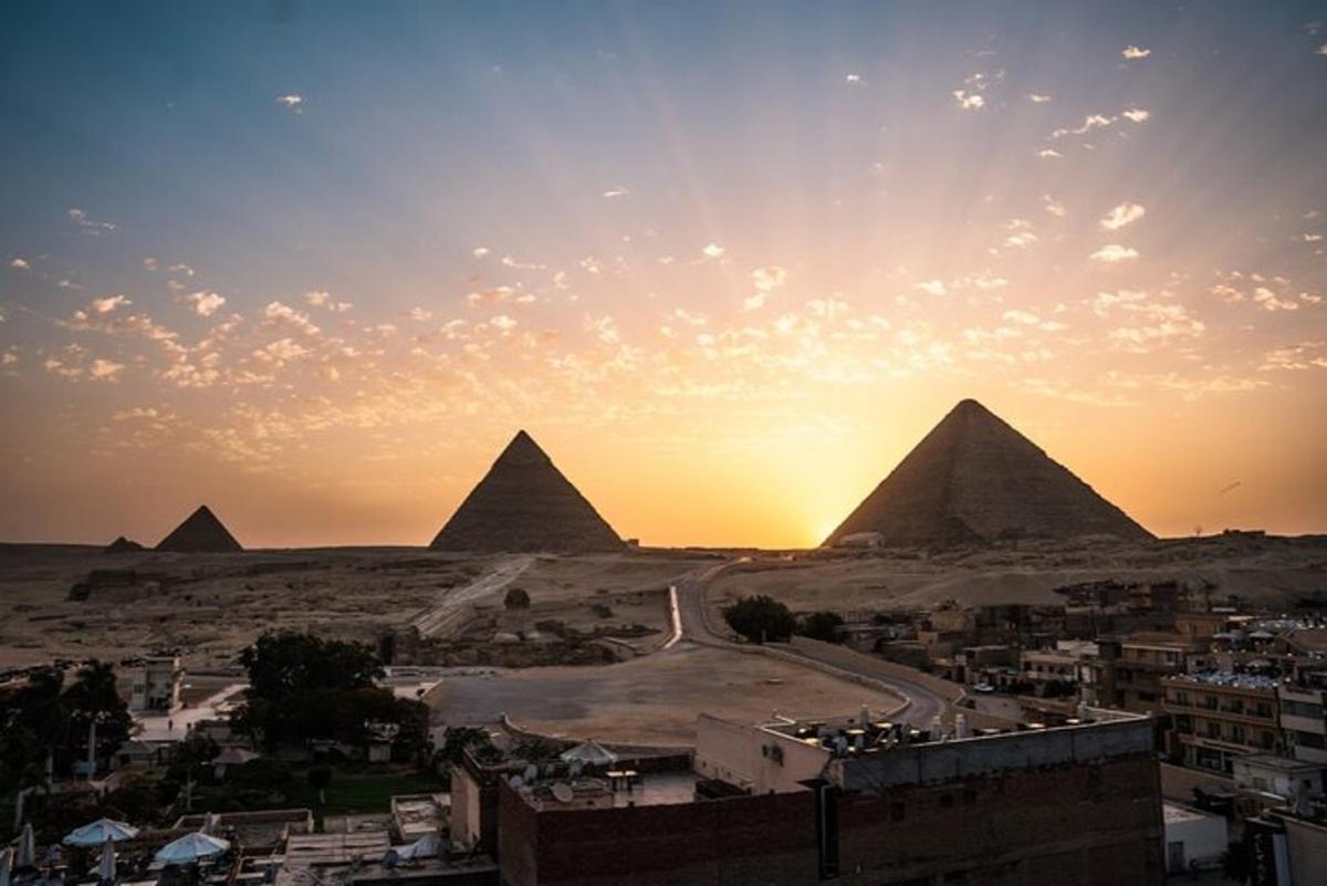 a view of the pyramids of giza at sunset