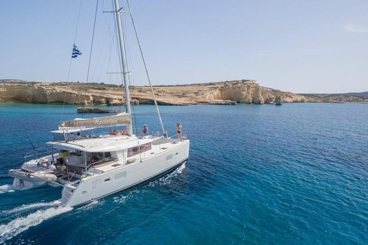 a white boat in the water with people on it