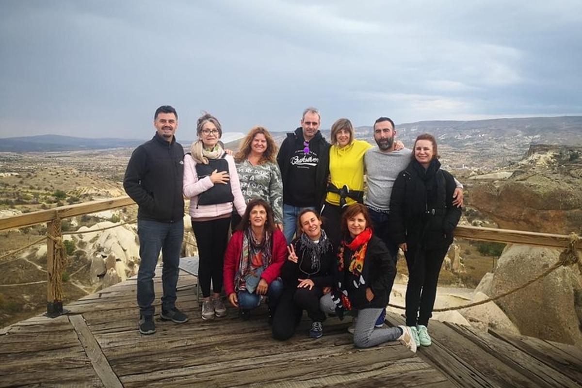 a group of people posing for a picture at the top of a mountain
