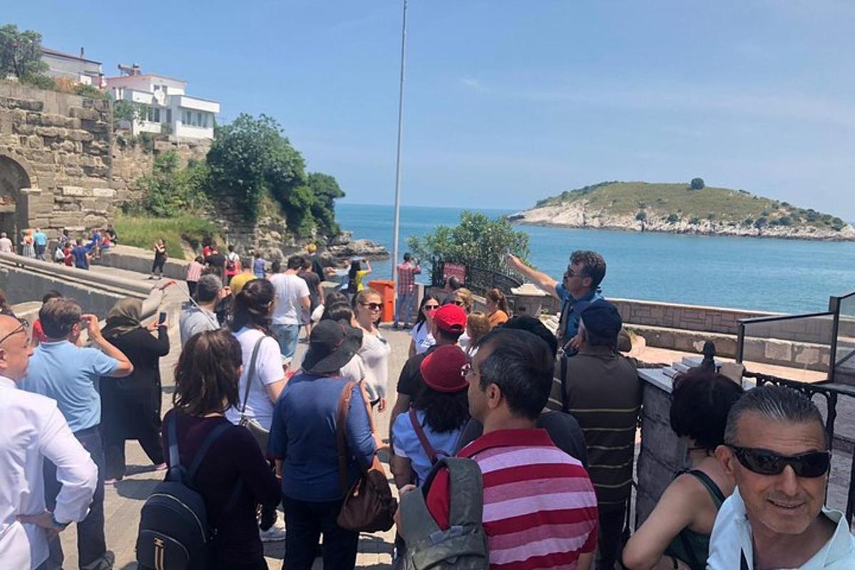 a crowd of people walking up a stairs near the water