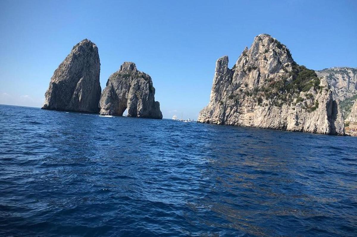 a view of the ocean with rocks in the water