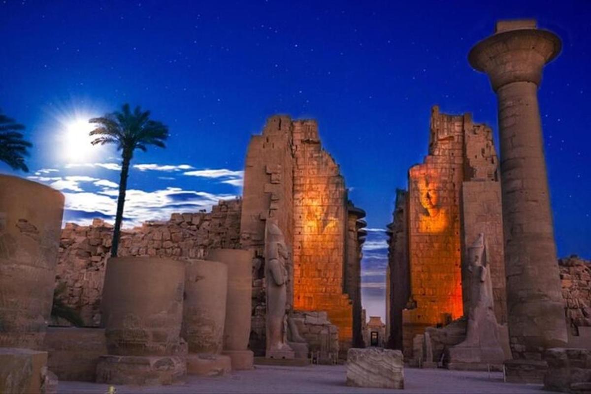 a view of the ruins of a temple at night
