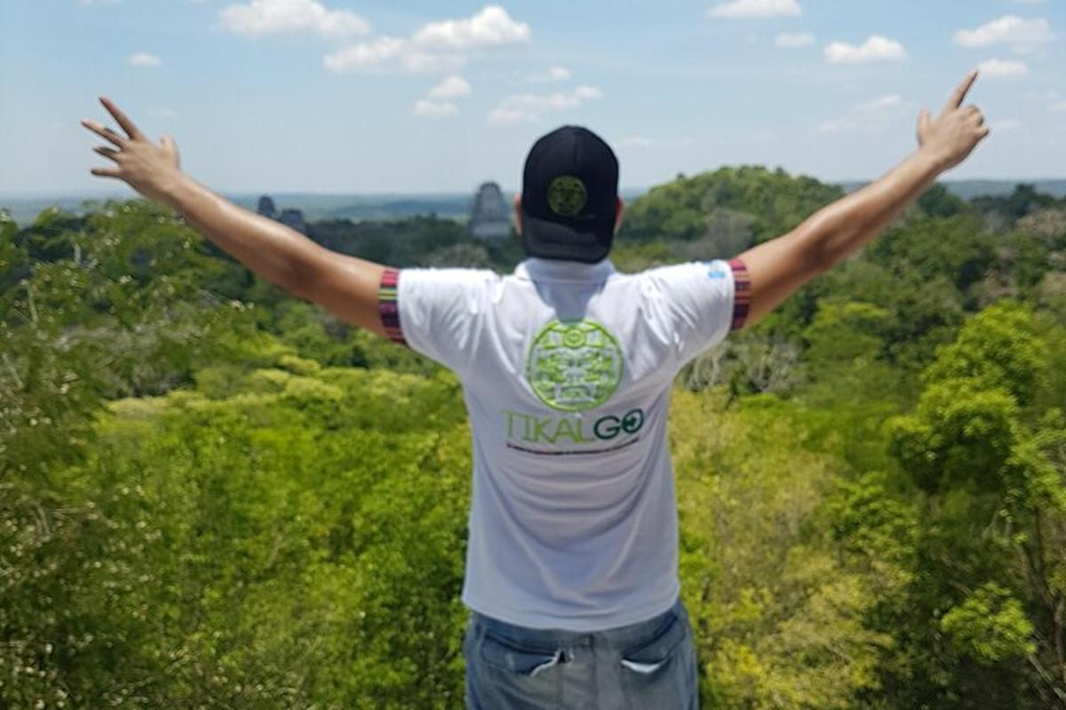 a man with his arms outstretched in a field