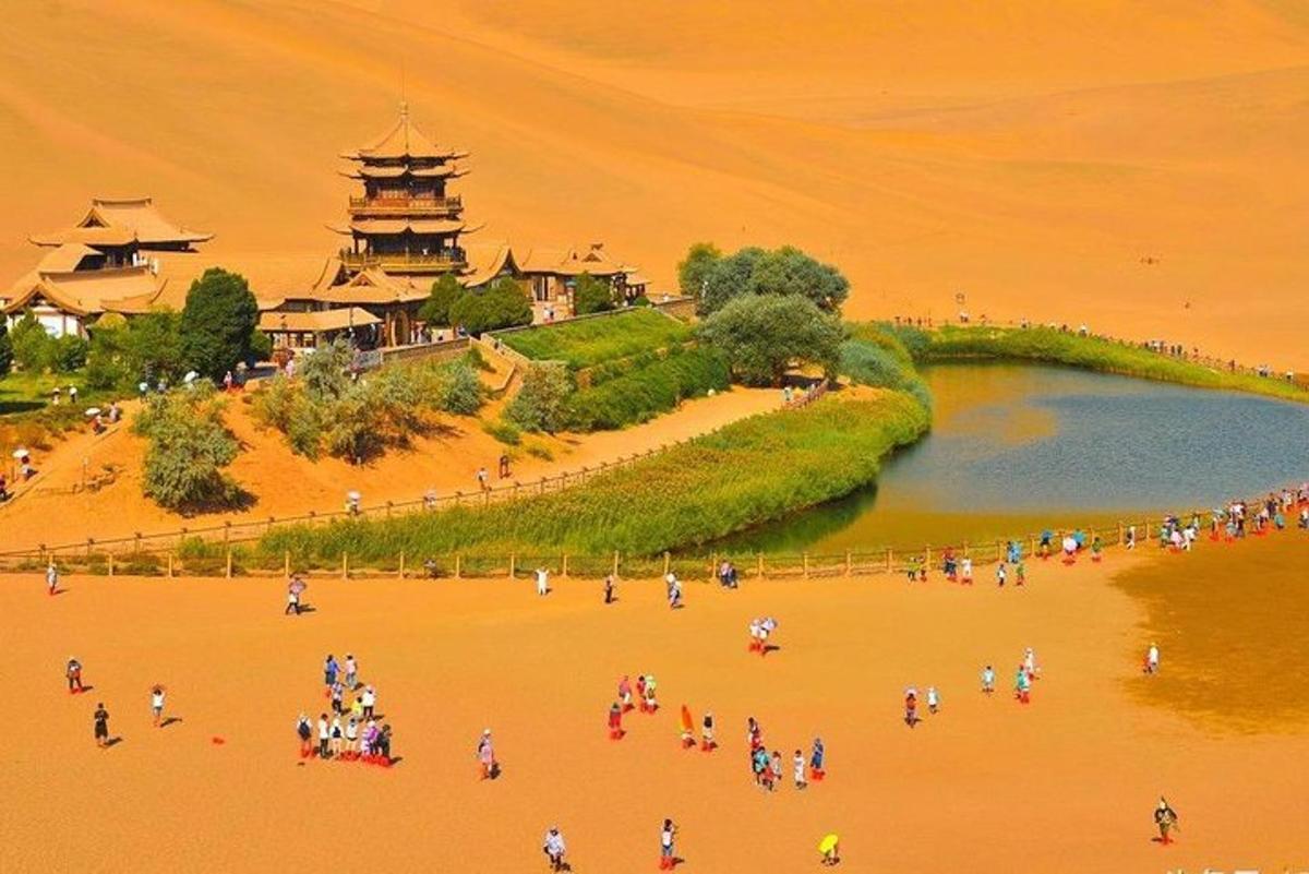 a group of people on a beach near a lake