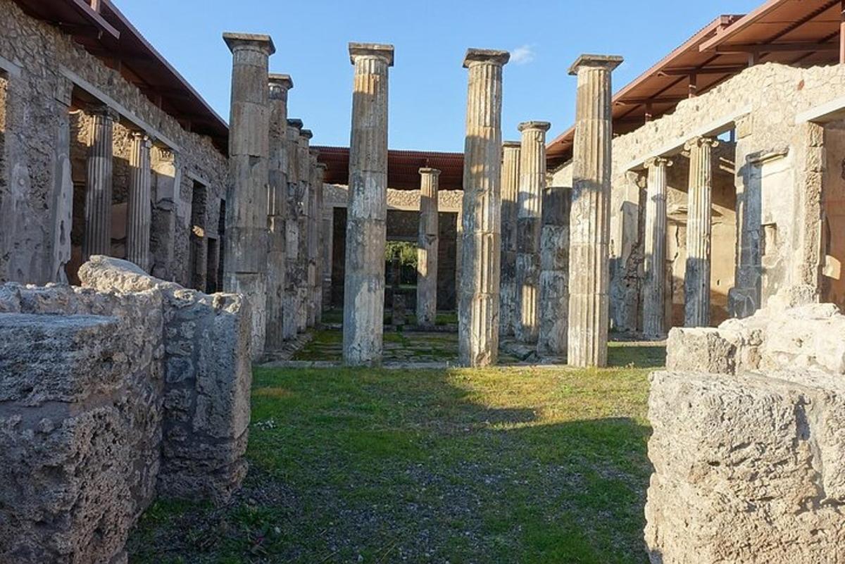 a group of ruins with columns in a yard