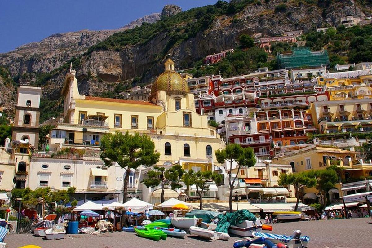 a group of buildings on a mountain with a beach