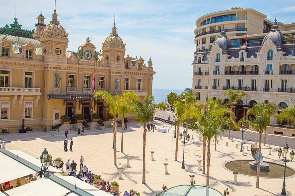 a plaza in front of a building with palm trees