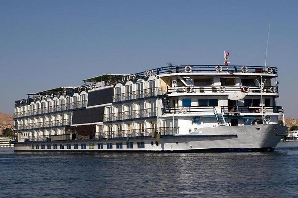 a cruise ship in the water next to a building