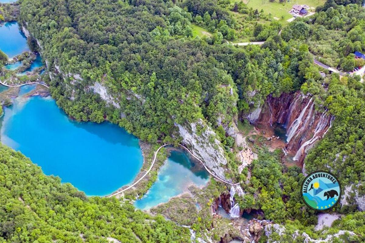 an aerial view of a blue lake in a forest