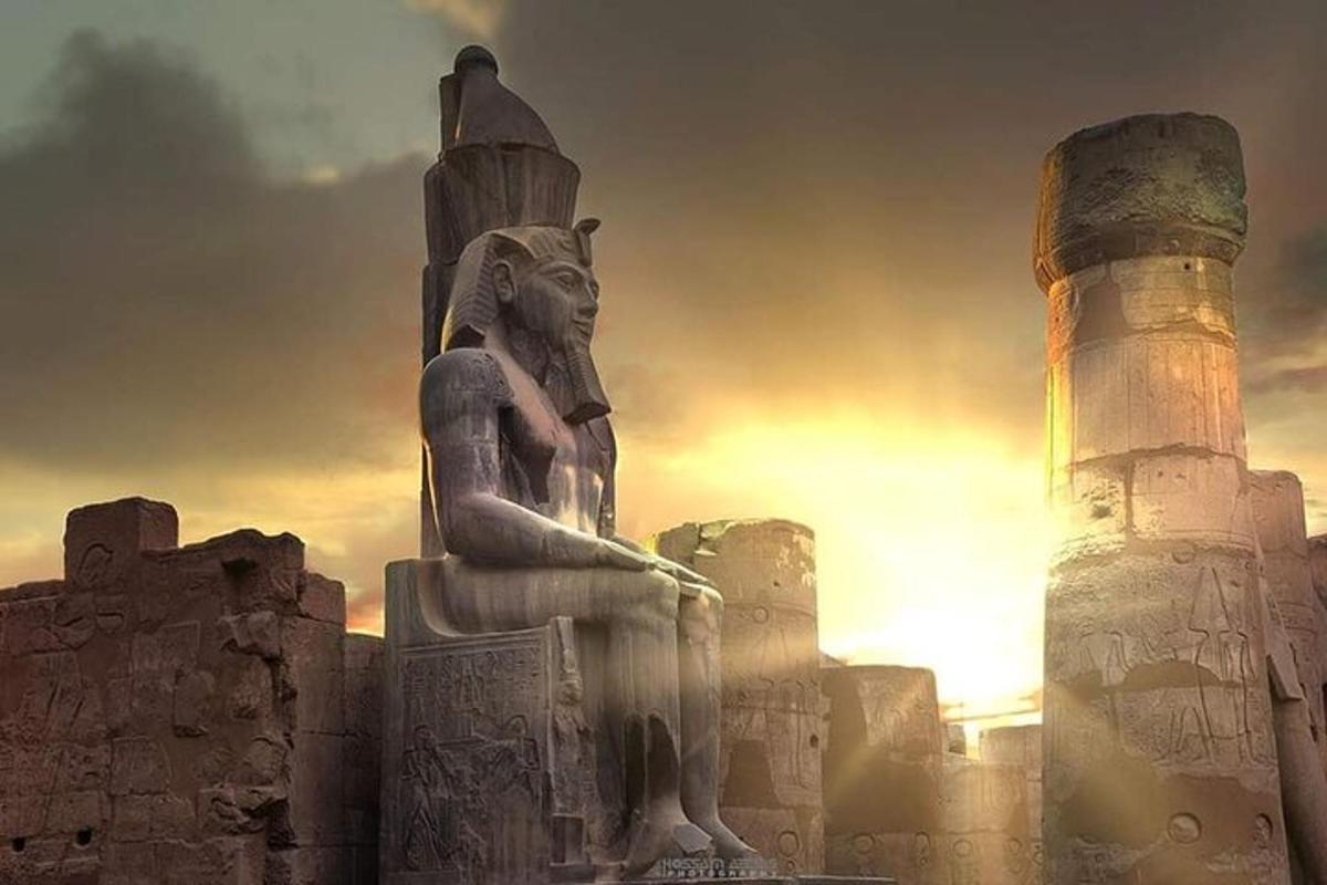 a statue of a man sitting on top of a monument