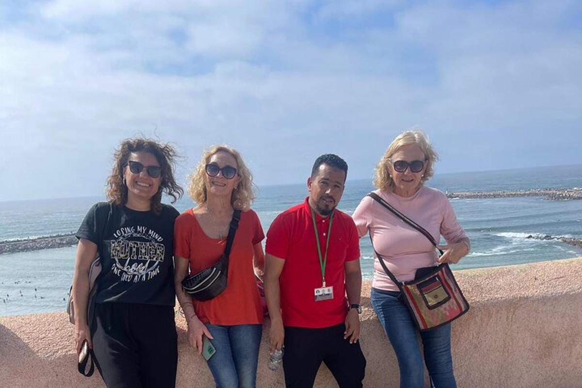 a group of people standing on the beach