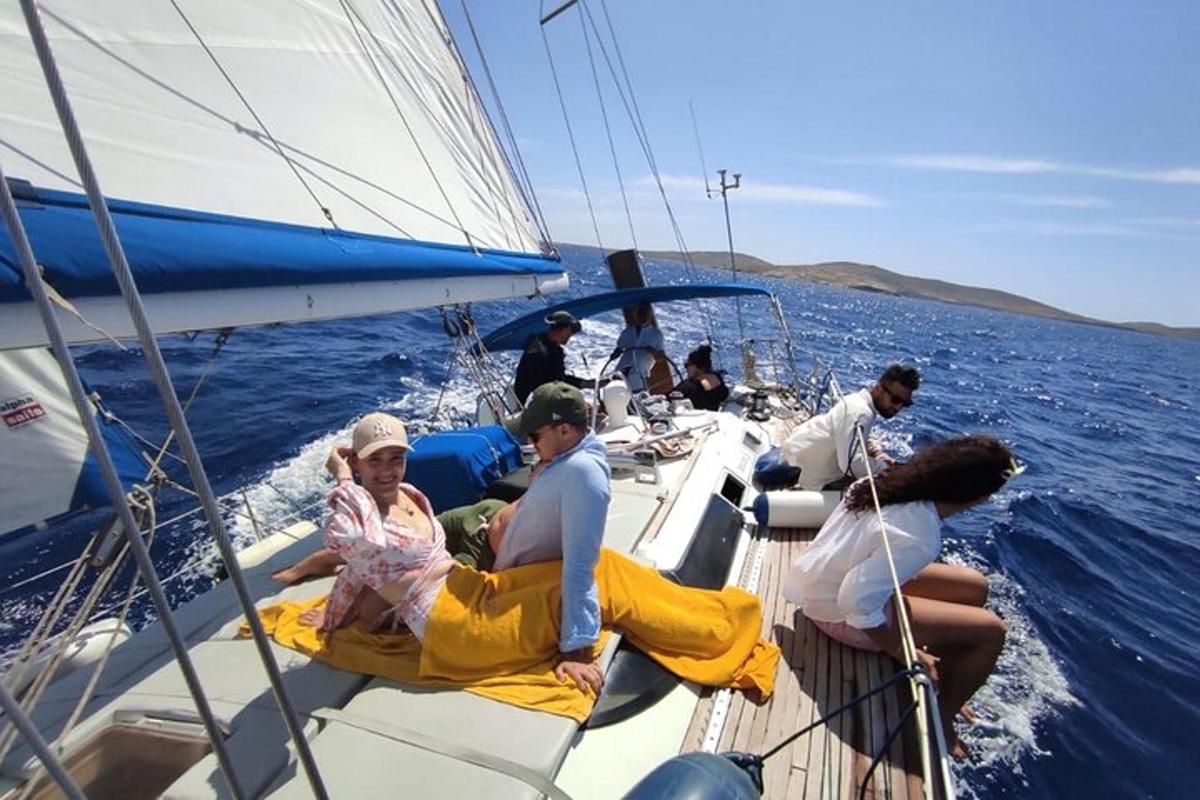 a group of people on a sailboat in the water