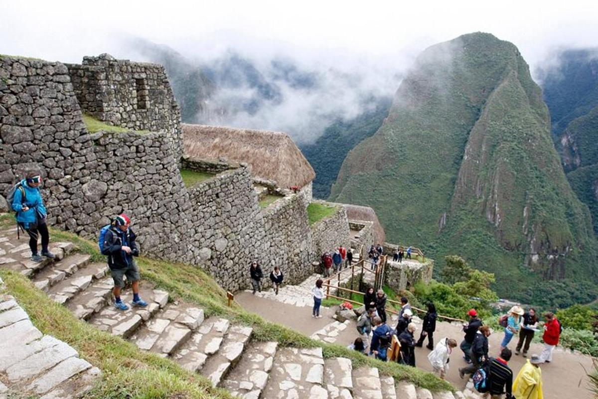 a group of people standing on the ruins of a mountain