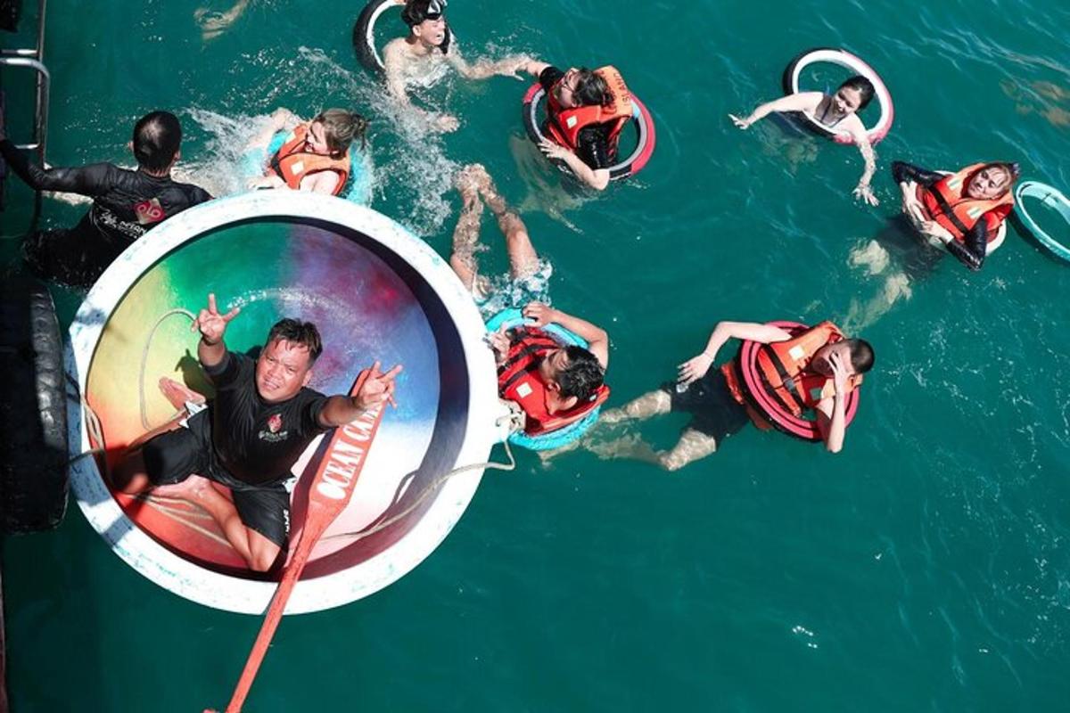 a group of people in the water in an inner tube