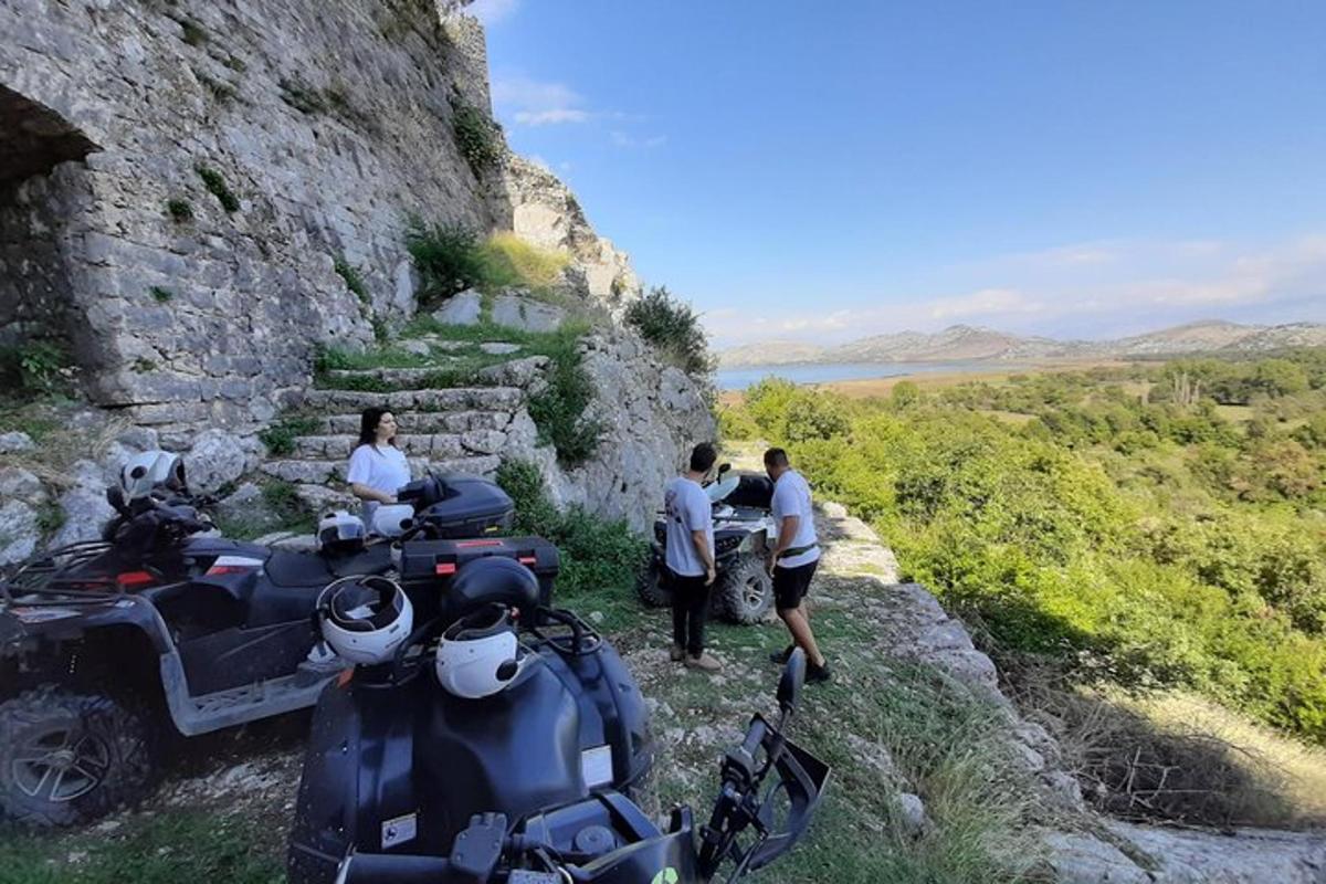 um grupo de pessoas em pé ao lado de motocicletas em uma montanha