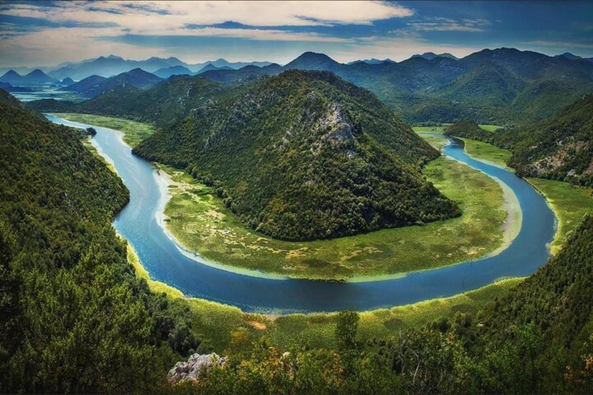 an aerial view of a river between two mountains