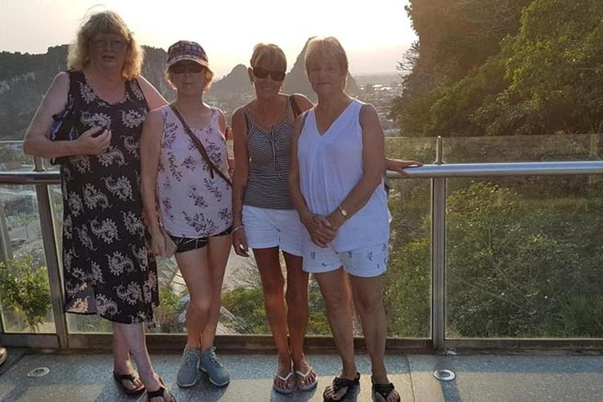 un grup de dones posant per a una foto en un balcó