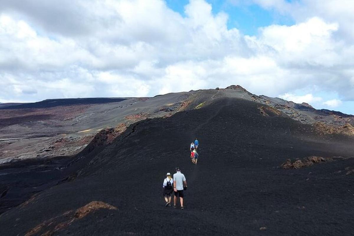 three people walking on top of a hill